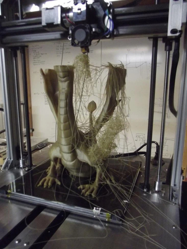 Dragon miniature tilted 45 degrees backward with tree supports underneath wings, showing reduced support material and better stability